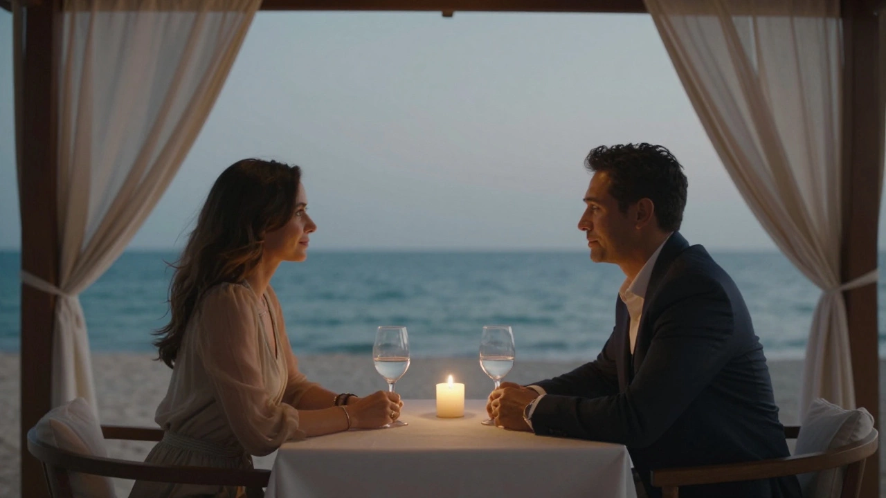 Two people sharing a quiet dinner in a beachside cabana, candlelight reflecting in their eyes as the ocean glows behind them.